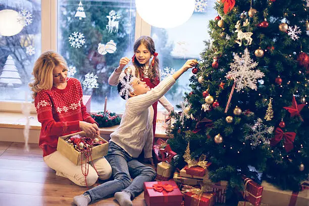 Photo of Family decorating Christmas tree