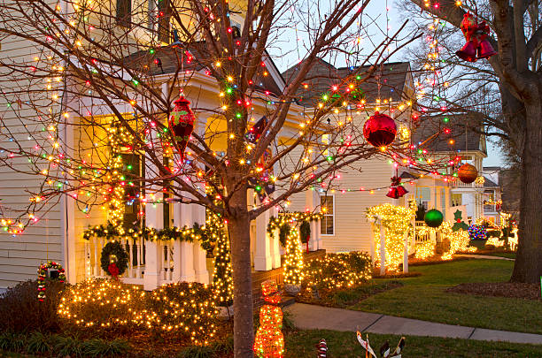 These traditional, Victorian-style homes in a Christmas town/village are beautifully decorated for the Holiday Season. Taken just before sunset with a long exposure to capture a beautiful blue sky.