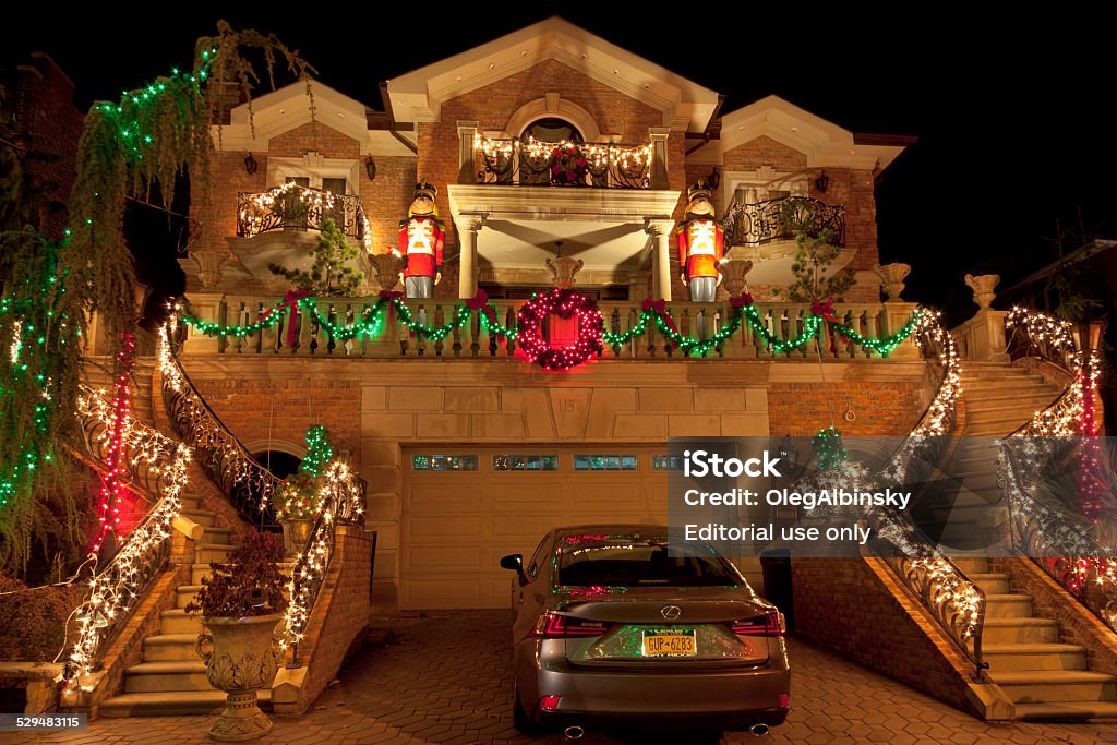 Luxury Brooklyn House with Christmas Lights at night, New York. New York, NY, USA - December 15, 2014: Luxury Home with Christmas Lights in Dyker Heights neighbourhood of Brooklyn, New York. Image taken at night. Wide angle lens. American Culture Stock Photo