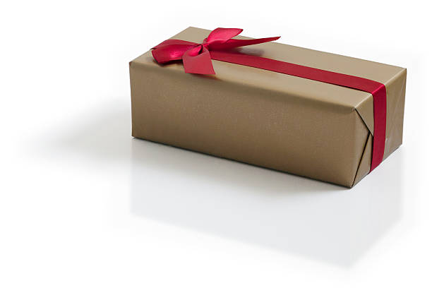 istock Gold gift with red satin ribbon bow 529483345
