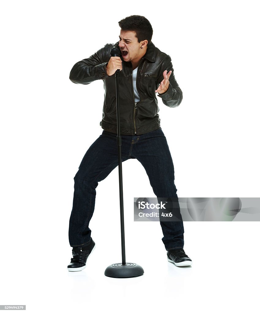 Man singing song with microphone Man singing song with microphonehttp://www.twodozendesign.info/i/1.png 20-24 Years Stock Photo