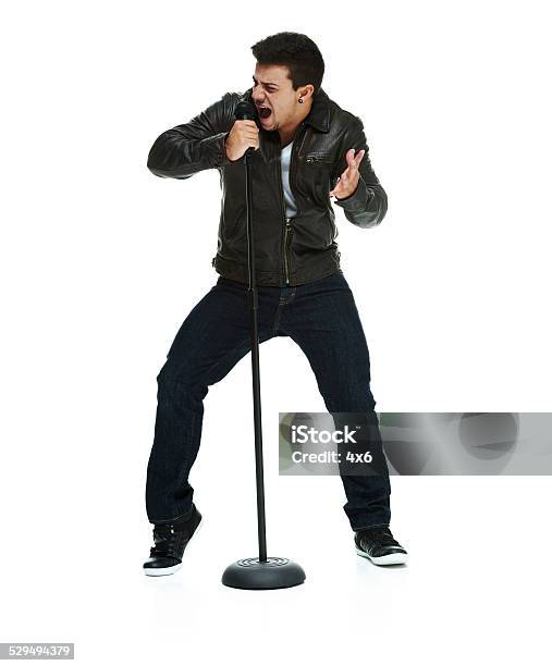 Man Singing Song With Microphone Stock Photo - Download Image Now - 20-24 Years, 20-29 Years, Adult