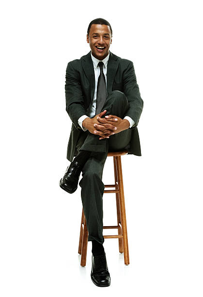 istock Cheerful businessman on stool & looking at camera 529494405