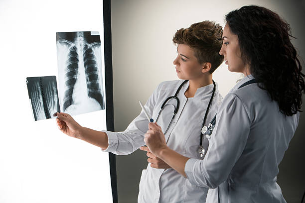 istock Two attractive young doctors looking at x-ray results 529494459