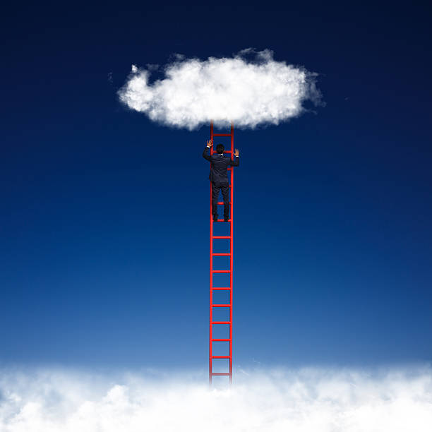 istock Businessman climbing on ladder 529497575