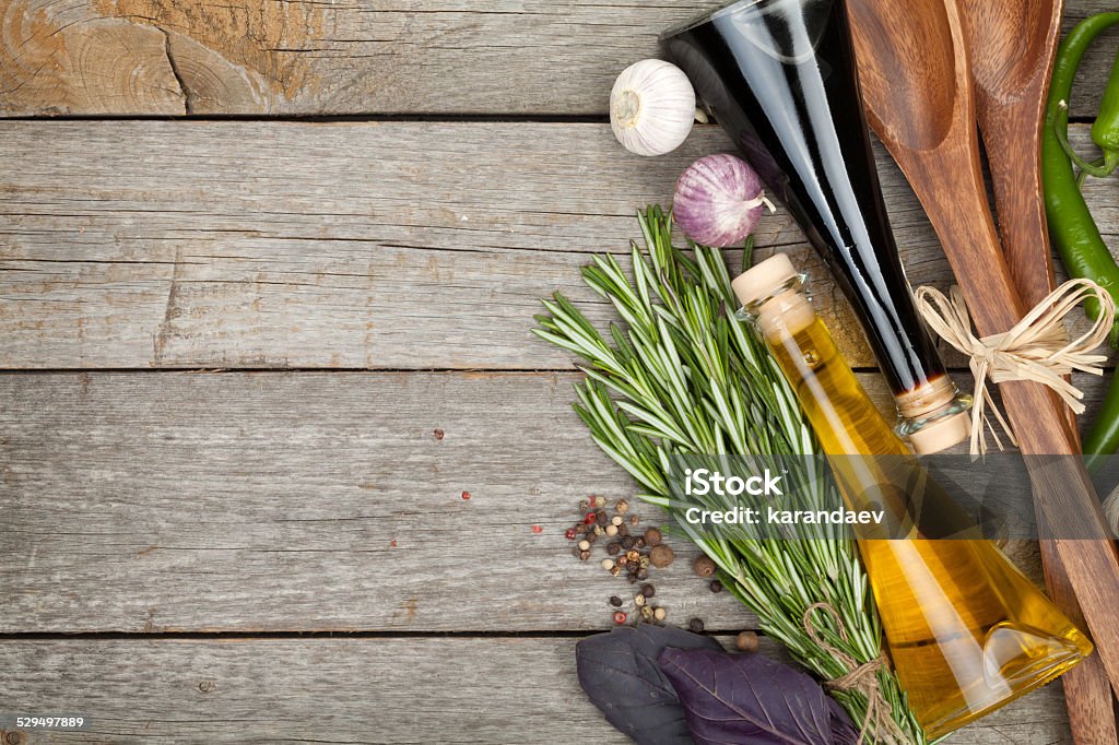Herbs, spices and seasoning Herbs, spices and seasoning with utensils over wooden table background with copy space Backgrounds Stock Photo