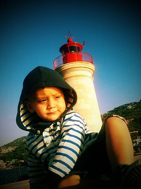 istock little boy in front of lighthouse 529499745