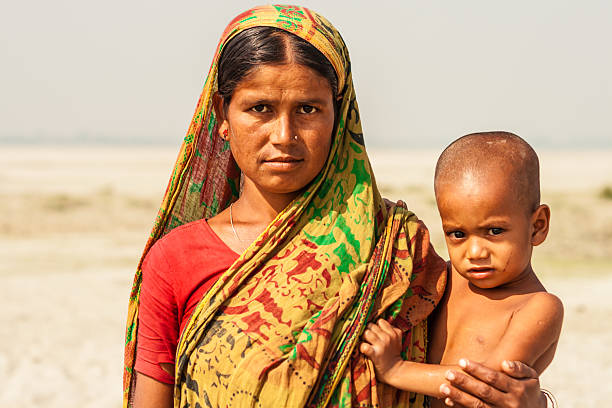 Bangladeshi Mother and Child Mother and young child pictured on a char island in the Jamuna River, north-western Bangladesh. bangladesh stock pictures, royalty-free photos & images