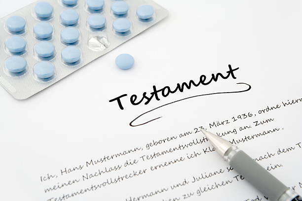 istock testament, last will, in german with pen and blue pills 529517009