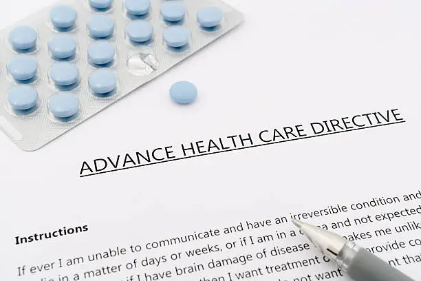 Photo of advance health care directive with blue pills ans grey pen