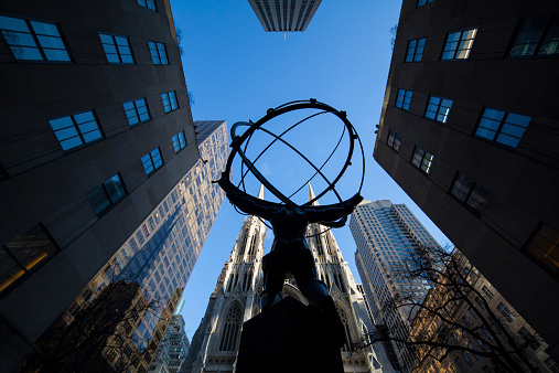 NYC, NY, USA - December 18, 2014: View of the Atlas holding the world on his shoulders, facing newly cleaned Saint Patrick's Cathedral.  Midtown Manhattan.