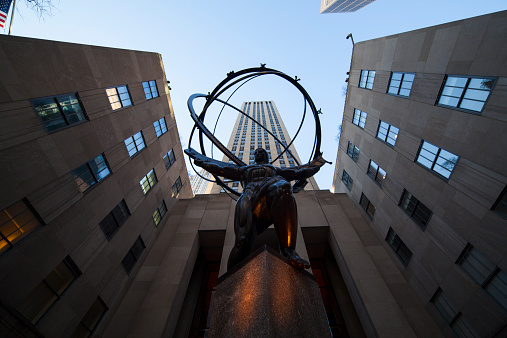 NYC, NY, USA - December 18, 2014: View of the Atlas holding the world on his shoulders. Rockefeller Center soars above him. Midtown Manhattan.