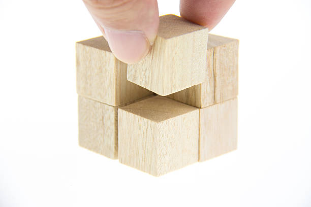 istock hand holding wooden toy blocks 529521083