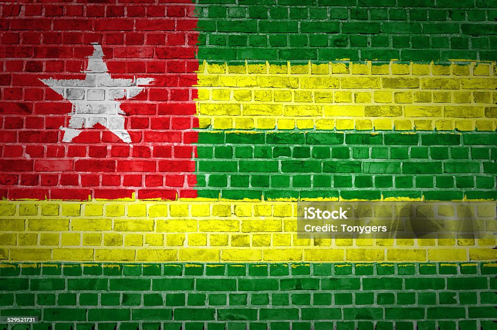 Brick Wall Togo An image of the Togo flag painted on a brick wall in an urban location Abstract Stock Photo