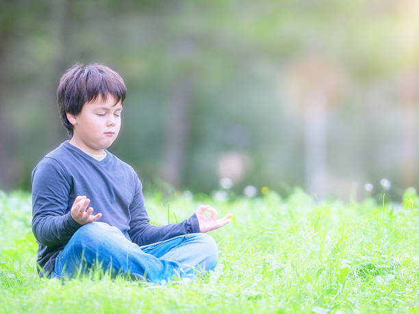 istock young boy meditating zen like in  nature 529522365