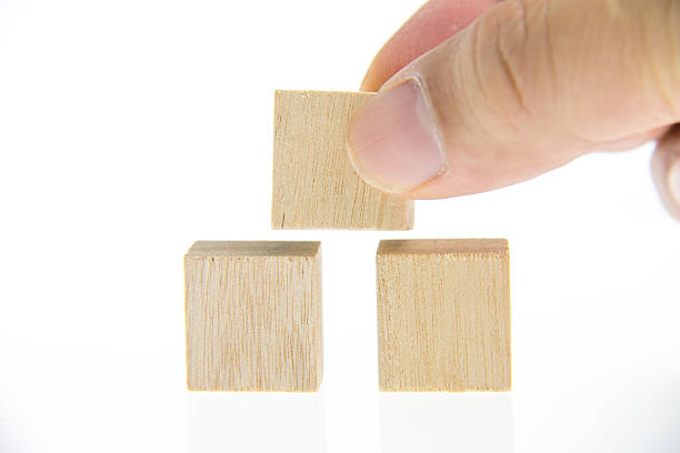 istock hand holding wooden toy blocks 529522985