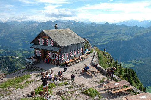 Schwyz, Switzerland - August 10, 2014: Mountain hostel, restaurant and unidentified people on Grosser Mythen peak nearby Schwyz in Switzerland.
