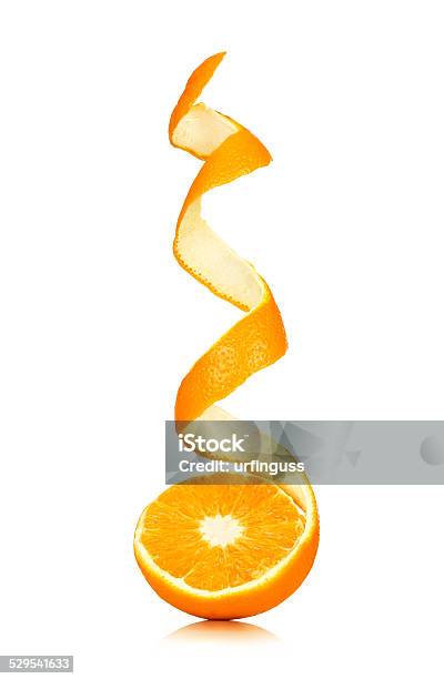 Juicy Orange With Peeled Spiral Skin Isolated On White Stock Photo - Download Image Now