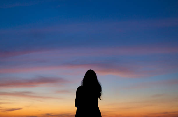 istock Woman in the shadow with nice sky 529541951