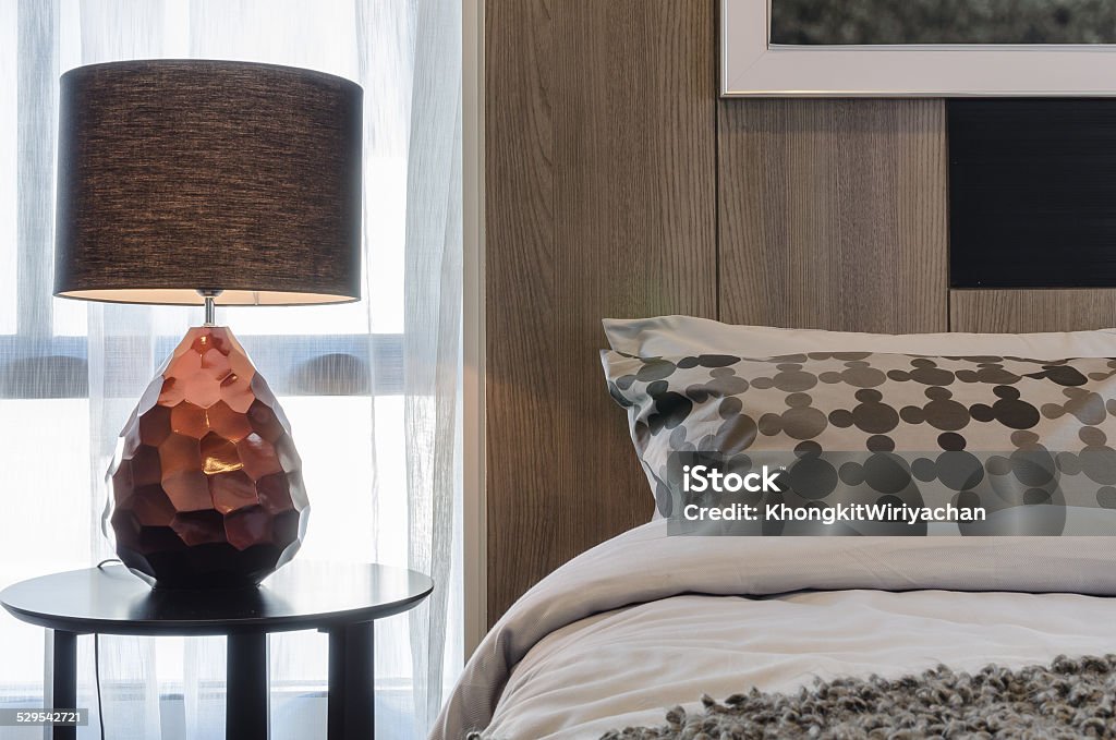 brown lamp on round table in bedroom Apartment Stock Photo