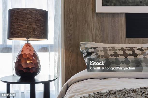 Brown Lamp On Round Table In Bedroom Stock Photo - Download Image Now - Apartment, Bed - Furniture, Bedding