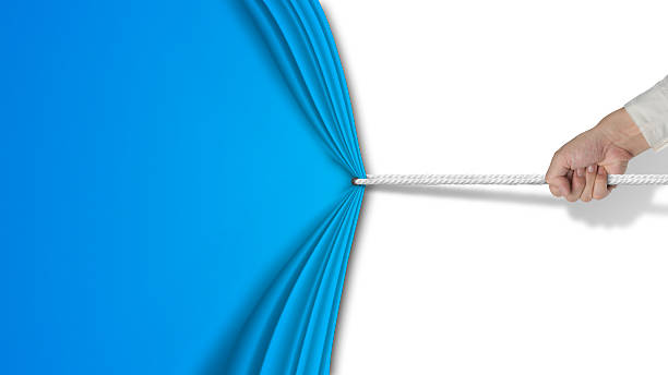 hand pulling open blue curtain with blank white background stock photo