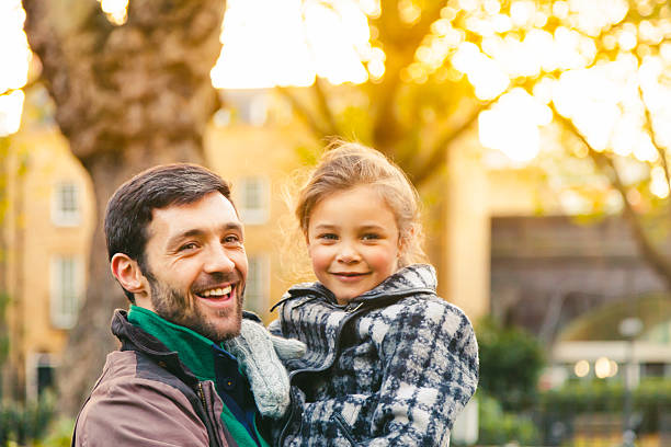istock Loving Father and Daughter smiling in a park 529544387