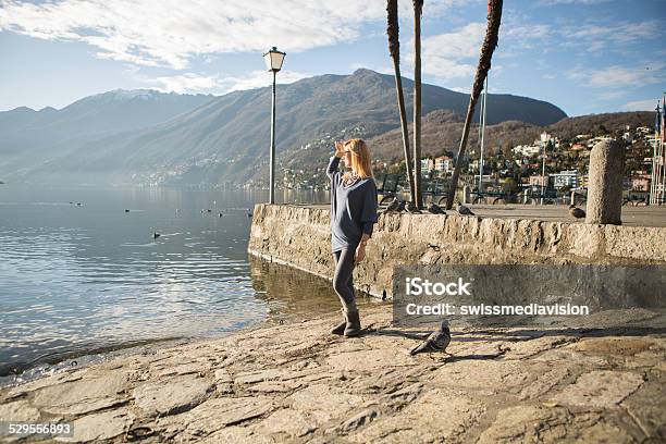 Young Woman Near Lake Looking At View On Sunny Dayautumn Stock Photo - Download Image Now
