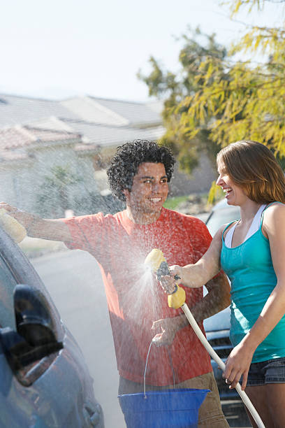 istock Couple washing the car 529557913