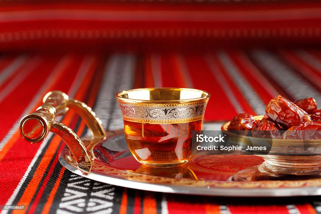Iconic Abrian fabric with Arabic tea and dates Iconic Abrian fabric is graced with symbols of Arabia, in particular Arabic tea and dates, they symbolise Arabian hospitality. Iftar Stock Photo