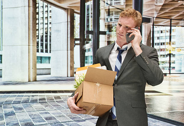 istock Businessman on mobile holding box 529559553
