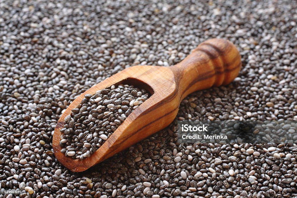 Chia seeds in wooden scoops, one of the superfoods Acid Stock Photo