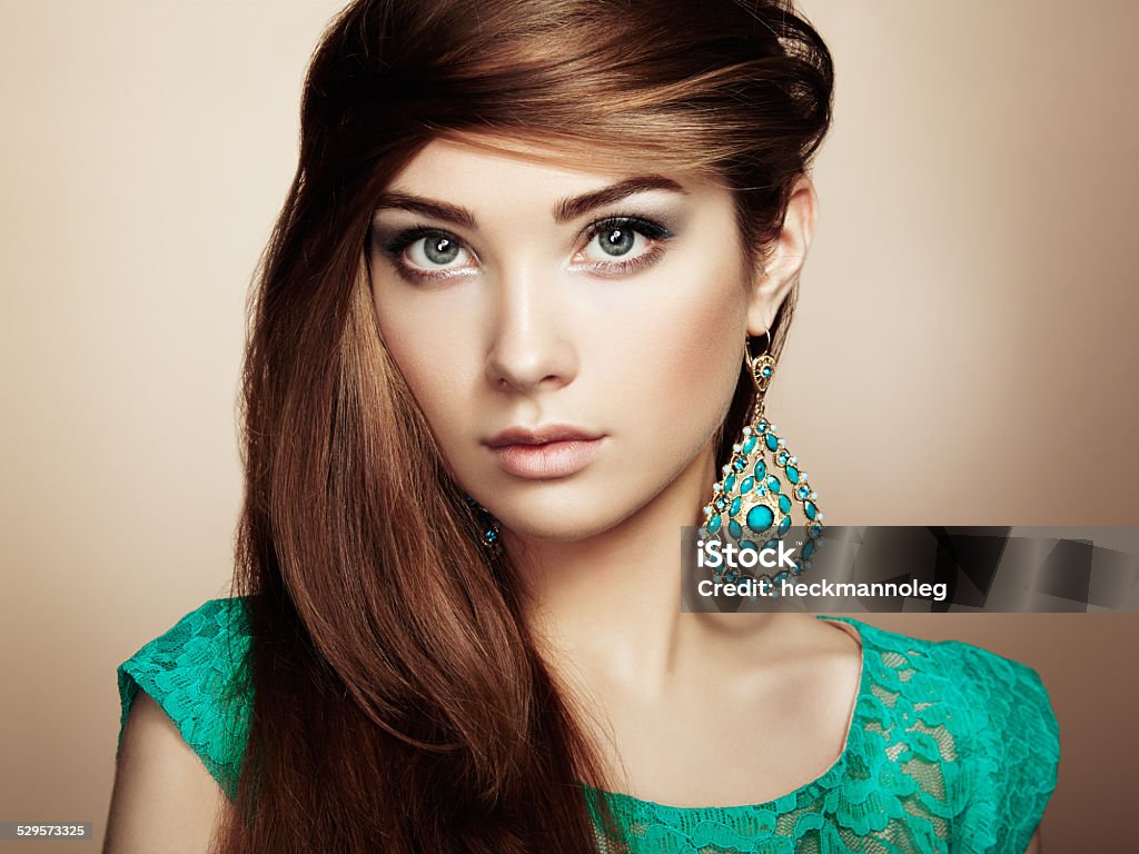 Portrait of beautiful young woman with earring Portrait of beautiful young woman with earring. Jewelry and accessories. Perfect makeup. Fashion photo Adult Stock Photo