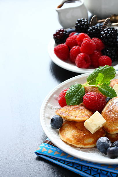 Dutch mini pancakes called poffertjes with berries
