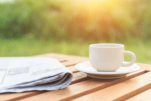 istock Close up Coffee cup and newspaper on the table 529576261