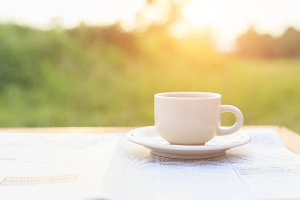 istock Close up Coffee cup and newspaper on the table 529576265