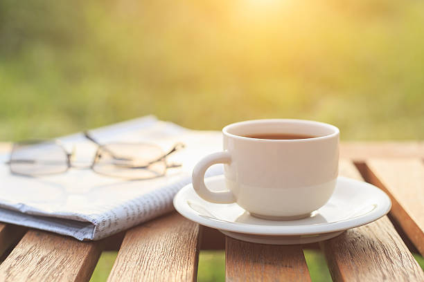 istock Close up Coffee cup and newspaper on the table 529576271