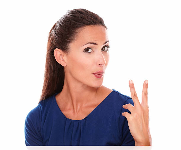 istock Lovely young woman making a victory sign 529577407
