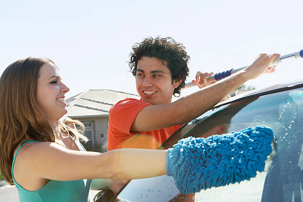 istock Couple washing the car 529578641