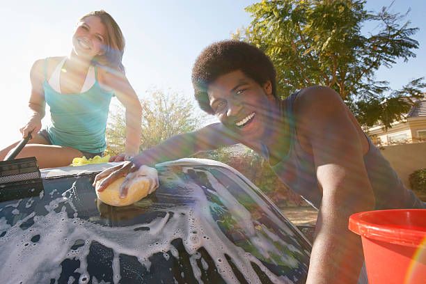 istock Couple washing the car 529578653