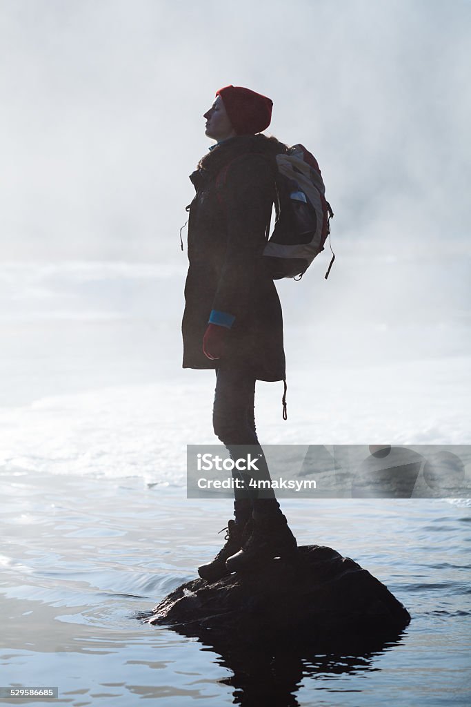 Girl hiking in the nature during sunset next to river Achievement Stock Photo