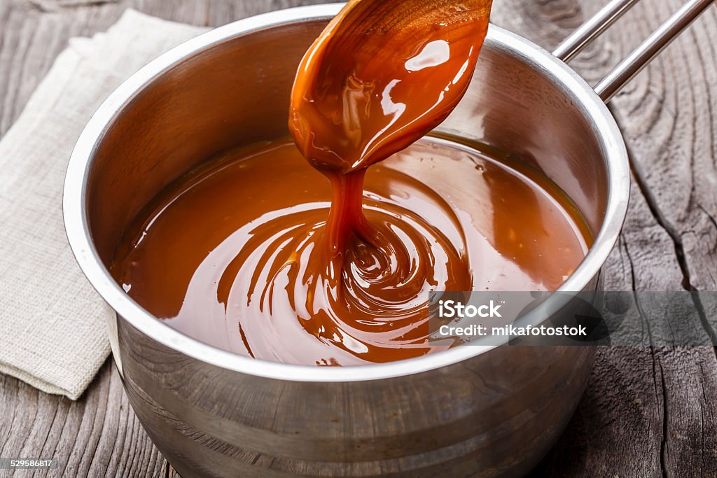 liquid caramel is poured into a gravy boat Caramel Stock Photo