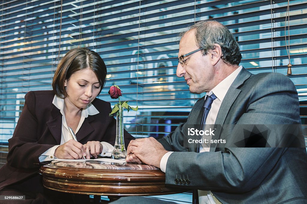 Old Businessman and Businesswoman talking at the Cafe Business man and Business woman meeting  and talking  at the cafe in Istanbul, Turkey Active Seniors Stock Photo