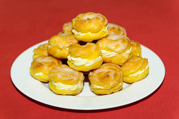 istock Cream puff pile on white plate 529588757