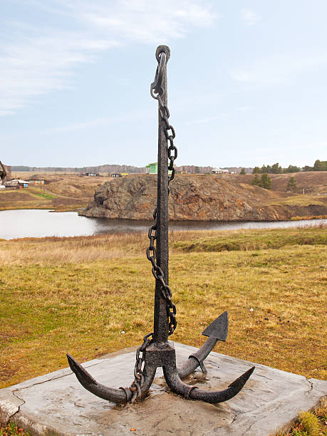 istock Large sea anchor on the shore 529589485