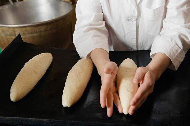 istock Female Baker Shaping Loaves 529597581