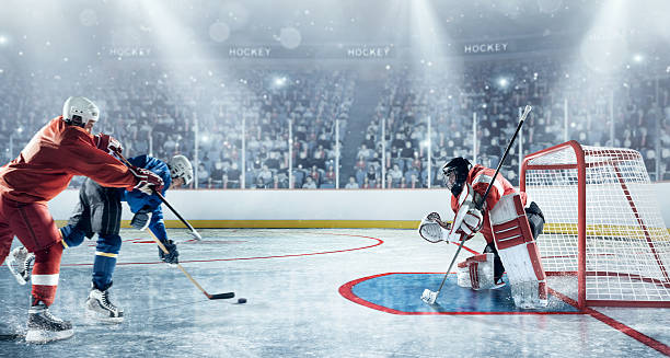 eishockey-spieler in aktion - ice hockey hockey puck playing shooting at goal stock-fotos und bilder