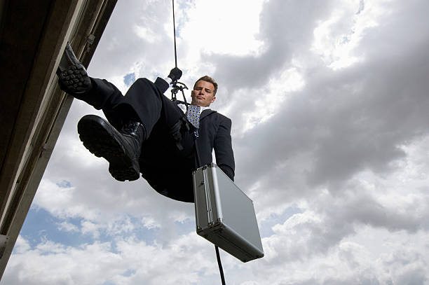 istock Businessman Rappelling Down By Rope 529599553