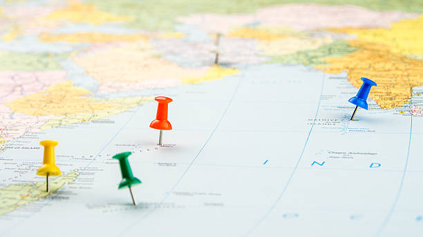 istock draw-pin stick into real map, identification of final destination 529600323