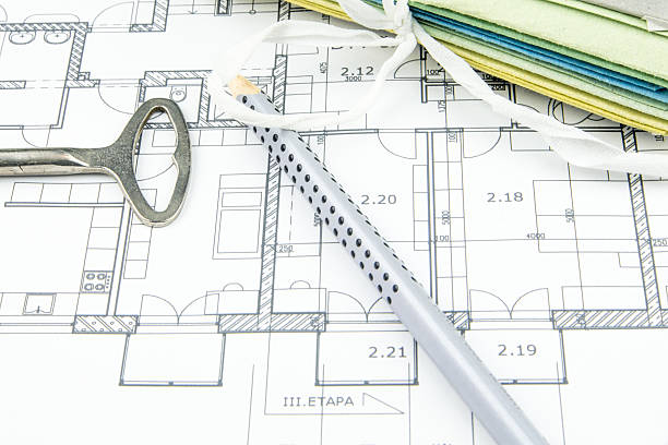 istock construction plan closeup with old key, pencil and hard desks 529600335
